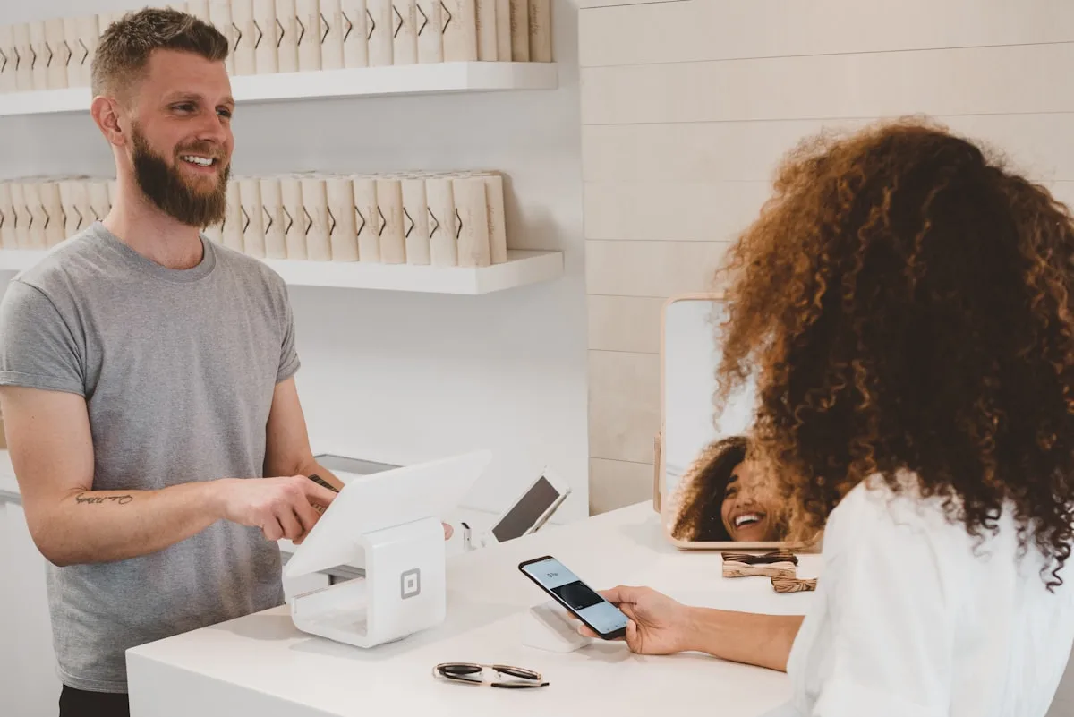 Small business owner using a tablet at a retail counter
